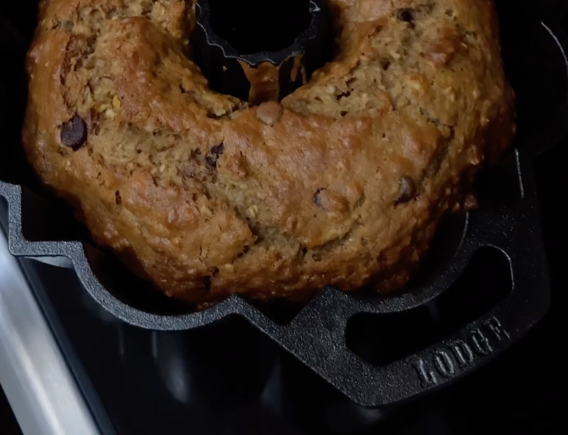 banana nut chip bread in Lodge cast iron fluted cake pan fresh out of the oven