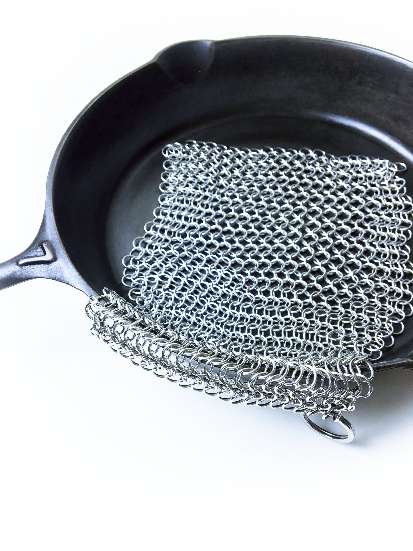 Chain mail for cast iron from Crisbee over a cast iron skillet